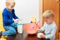 Two kid boys cooking, making cake in bowl Royalty Free Stock Photo