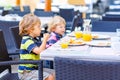 Two kid boys having healthy breakfast in restaurant Royalty Free Stock Photo