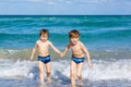 Two kid boys running on ocean beach in Florida Royalty Free Stock Photo