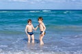 Two kid boys running on ocean beach. Little children having fun Royalty Free Stock Photo