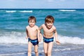 Two kid boys running on ocean beach. Little children having fun Royalty Free Stock Photo