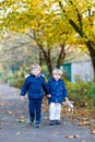 Two kid boys walking together in autumn park Royalty Free Stock Photo