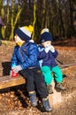 Two kids on a bench.