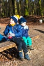 Two kids on a bench.