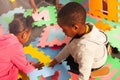 Two kids black boy and girl play with letters