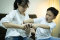 Two kids boy and child girl fighting for smartphone,sibling pulling mobile phone one another,shout and quarrel,children arguing Royalty Free Stock Photo