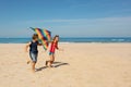 Two kids boy and girl run with color kite on beach Royalty Free Stock Photo