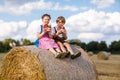 Two kids, boy and girl in traditional Bavarian costumes in wheat field Royalty Free Stock Photo
