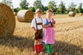 Two kids, boy and girl in traditional Bavarian costumes in wheat field Royalty Free Stock Photo