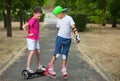 Two kids boy on roller skates and girl on self-balancing scooter wrapped