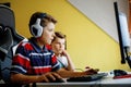 Two kids boys playing computer games on desktop pc. Modern addict activity for children. Siblings and friends gaming at Royalty Free Stock Photo