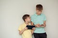 Two kids boys playing games or looking information video at Internet on mobile phones at home Royalty Free Stock Photo