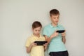 Two kids boys playing games or looking information video at Internet on mobile phones at home Royalty Free Stock Photo