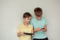 Two kids boys playing games or looking information video at Internet on mobile phones at home Royalty Free Stock Photo