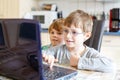 Two kids boys playing online chess board game on computer Royalty Free Stock Photo