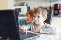 Two kids boys playing online and surfing in internet on computer Royalty Free Stock Photo