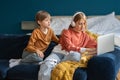 Children brother and sister sitting together with laptop on couch Royalty Free Stock Photo