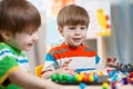 Two kids brothers play together at table