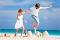 Two kids crushing sandcastle Royalty Free Stock Photo