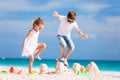 Two kids crushing sandcastle Royalty Free Stock Photo