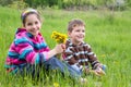 Two kids with dandelions Royalty Free Stock Photo