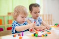 Two kids doing arts and crafts in day care centre Royalty Free Stock Photo