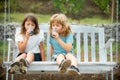 Two kids drink green smoothie outdoors at summer park. Brother and sister happy walking in nature. Siblings boy and girl Royalty Free Stock Photo