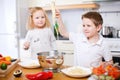 Two kids eating spaghetti