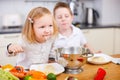 Two kids eating spaghetti