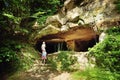 Two kids exploring old caves dug into the tuff rock and used for human habitation in ancient times. Citta del Tufo archaeological