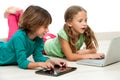 Two kids on floor with laptop and tablet. Royalty Free Stock Photo