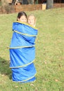 Two kids - girls in blue kids tunnel Royalty Free Stock Photo