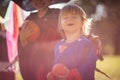 Two kids in Halloween suits standing in park and holding pumpkins Royalty Free Stock Photo