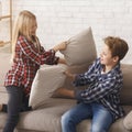 Two Kids Having Pillow Fight Playing On Couch Indoor Royalty Free Stock Photo