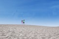 Two kids jump on desert
