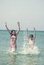 Two kids jumping and playing in the ocean Royalty Free Stock Photo