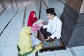 two kids learning to read quran with muslim teacher or ustad Royalty Free Stock Photo