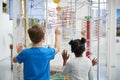 Two kids looking at a science exhibit, back view Royalty Free Stock Photo