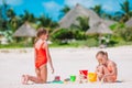 Two kids making sand castle and having fun at tropical beach Royalty Free Stock Photo