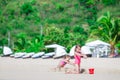 Two kids making sand castle and having fun at tropical beach Royalty Free Stock Photo