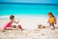 Two kids making sand castle and having fun at tropical beach Royalty Free Stock Photo