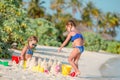 Two kids making sand castle and having fun at tropical beach Royalty Free Stock Photo