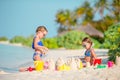 Two kids making sand castle and having fun at tropical beach Royalty Free Stock Photo