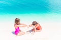 Two kids making sand castle and having fun at tropical beach Royalty Free Stock Photo
