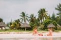 Two kids making sand castle and having fun at tropical beach Royalty Free Stock Photo