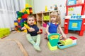 Two kids play role game in toy shop at home Royalty Free Stock Photo