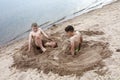 Two kids play on sandy beach of Lake Seliger Royalty Free Stock Photo