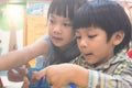Two kids are playing with educational toy in classroom Royalty Free Stock Photo