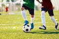 Two Kids Playing Football Ball on Grass Field. Happy School Boys Kicking Ball During Tournament Game Royalty Free Stock Photo