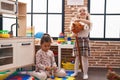 Two kids playing with hoops and horse toy at kindergarten Royalty Free Stock Photo